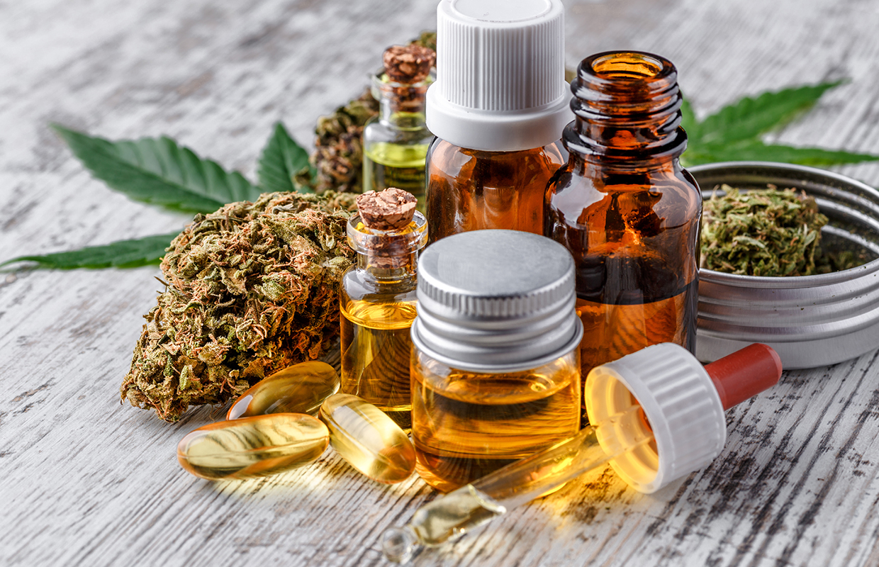 Green leaves of medicinal cannabis with extract oil.Medical marijuana flower buds. Hemp buds medical marijuana concept Green leaves of medicinal cannabis with extract oil.Medical marijuana flower buds. Hemp buds medical marijuana concept