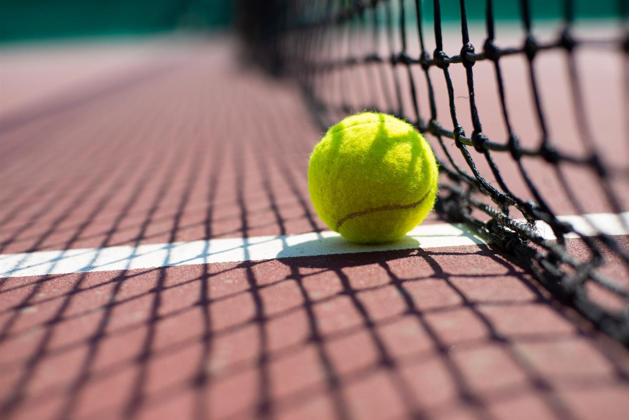 Tennis ball lying on the court. Healthy lifestyle concept Tennis ball lying on the court. Healthy lifestyle concept