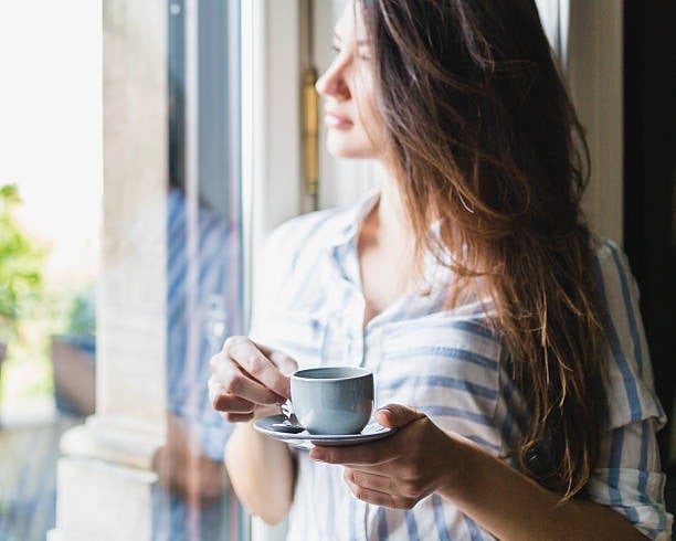 woman drinks coffee at home